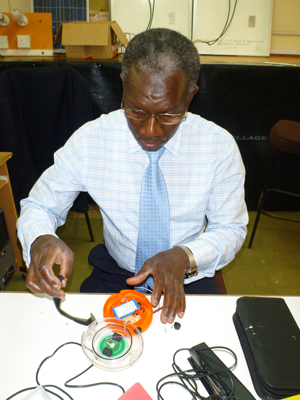One of the Senegalese lighting quality experts practically examines a solar lantern at the University of Nairobi during a recent training.